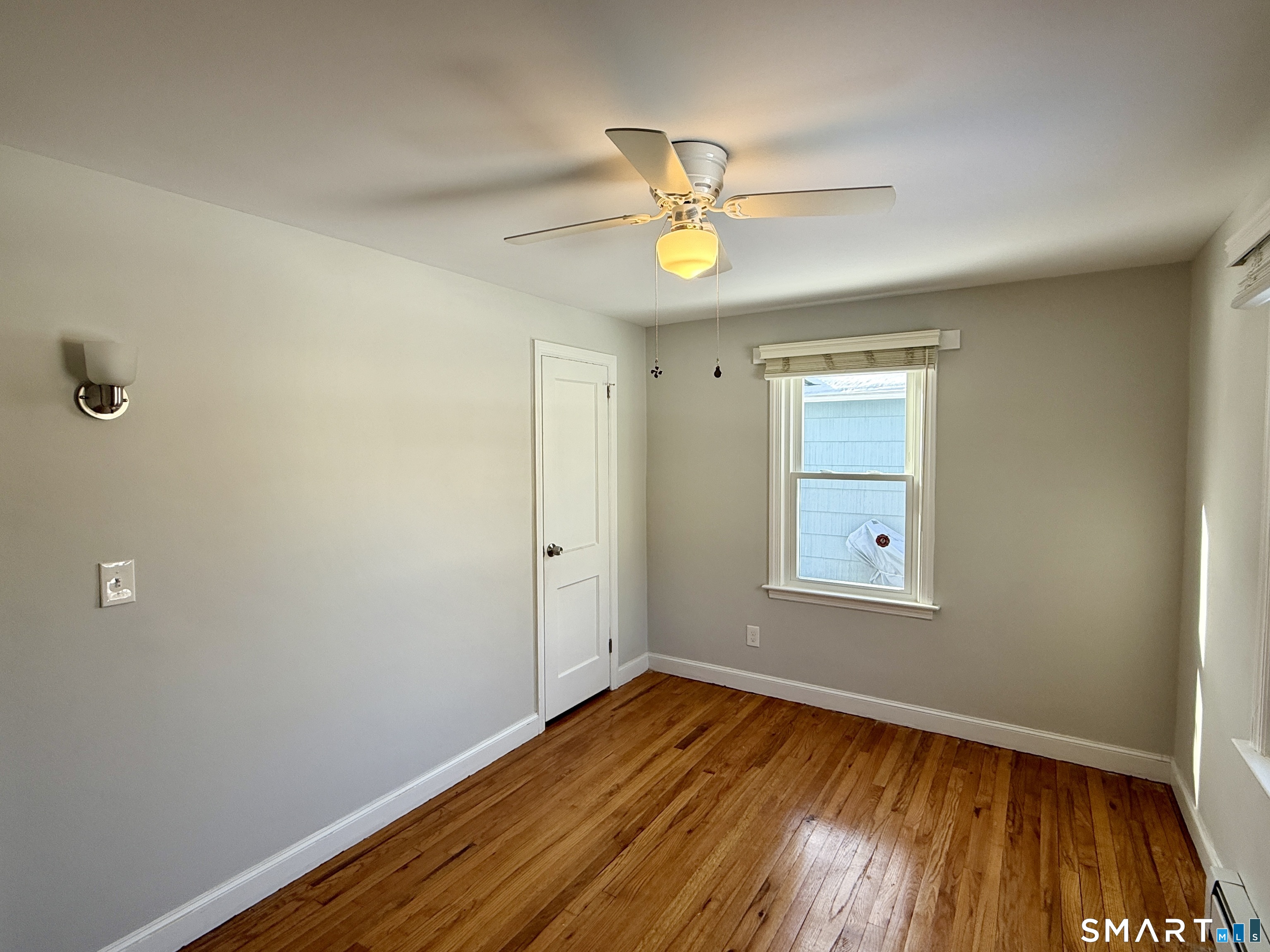 148 Lois Street Torrington, CT 06790 - Photo 11 of 17 a view of empty room with wooden floor and fan