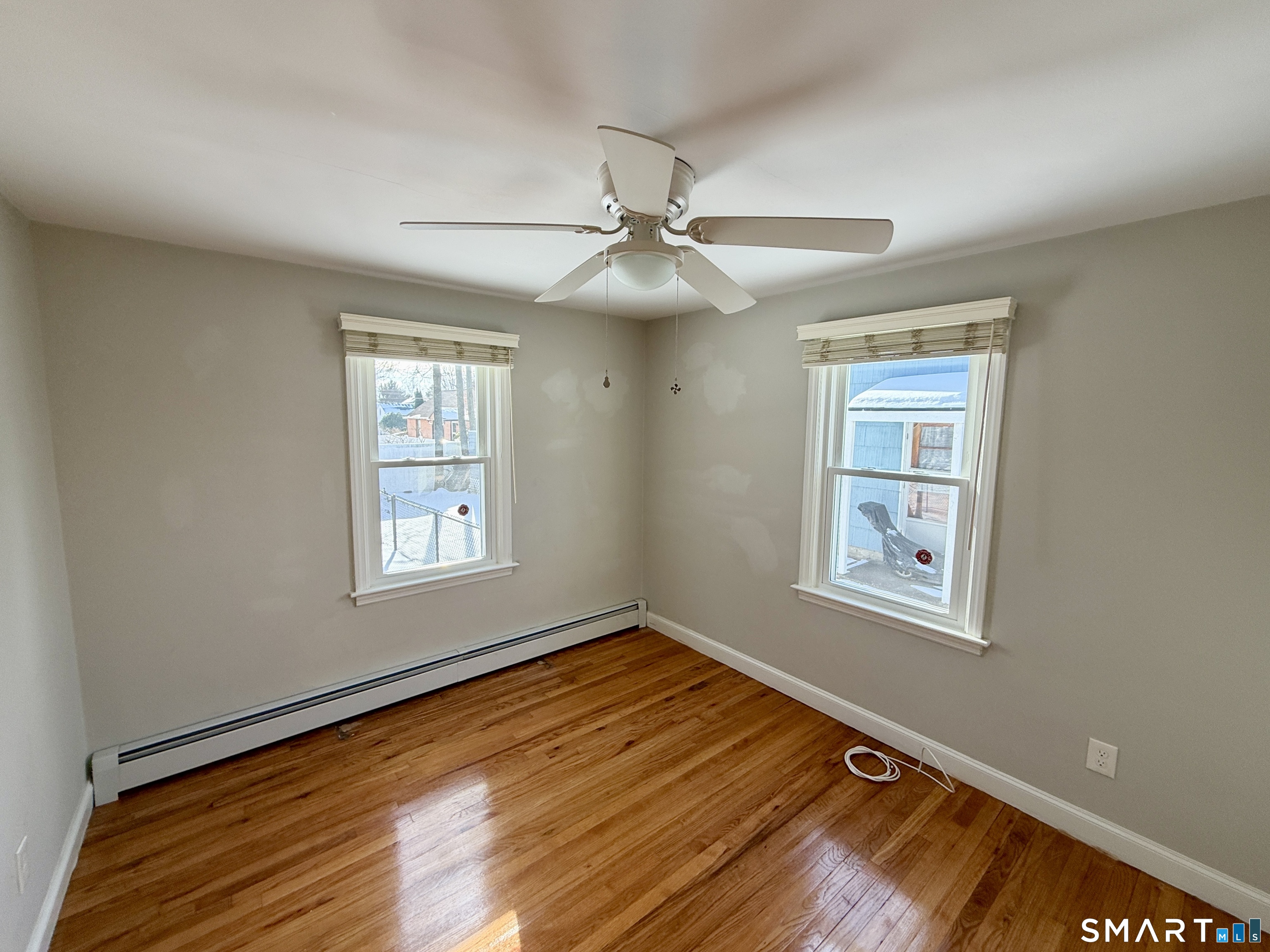148 Lois Street Torrington, CT 06790 - Photo 12 of 17 a view of an empty room with a window and wooden floor