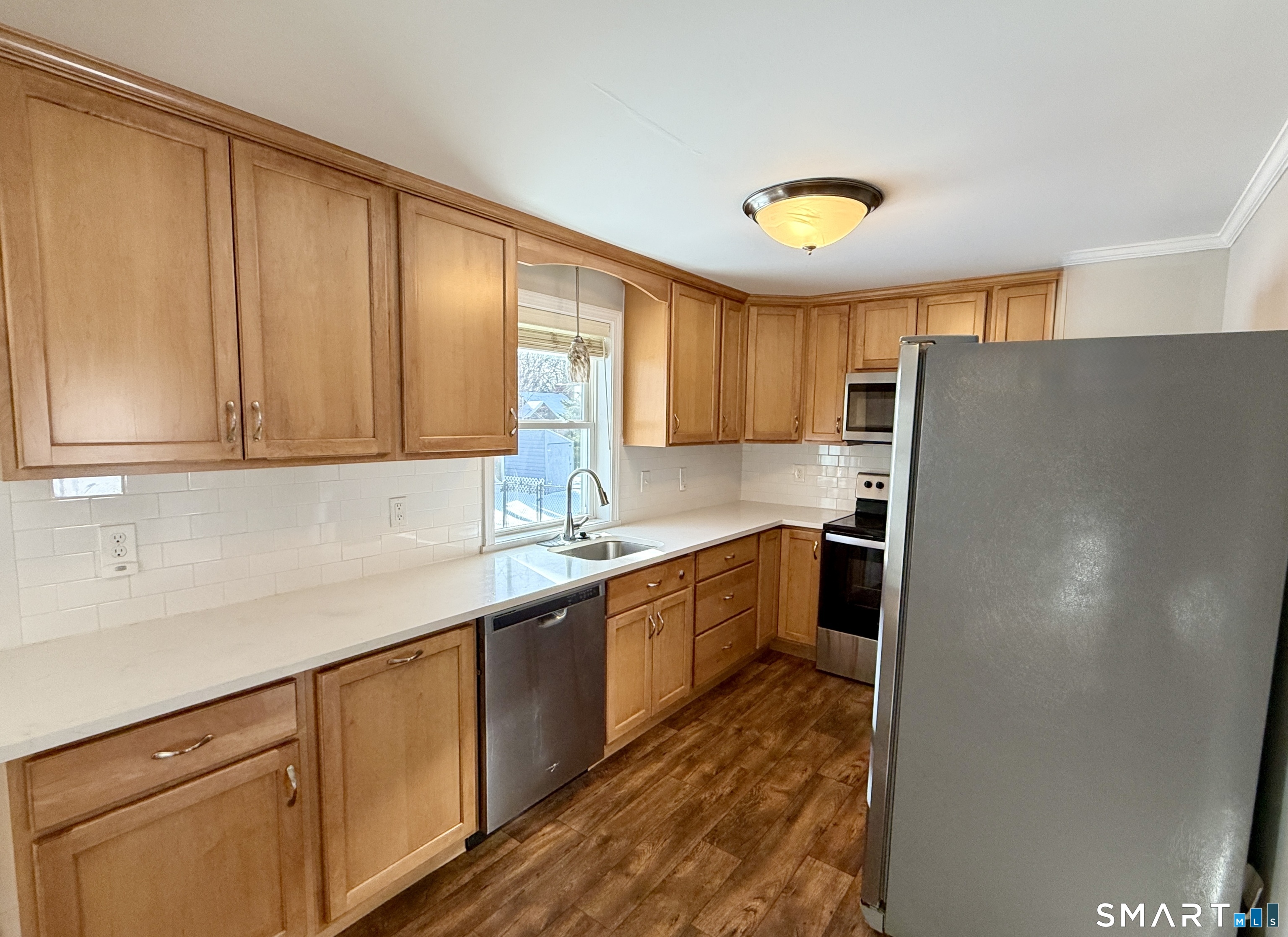 148 Lois Street Torrington, CT 06790 - Photo 4 of 17 a kitchen with stainless steel appliances granite countertop a refrigerator sink and cabinets