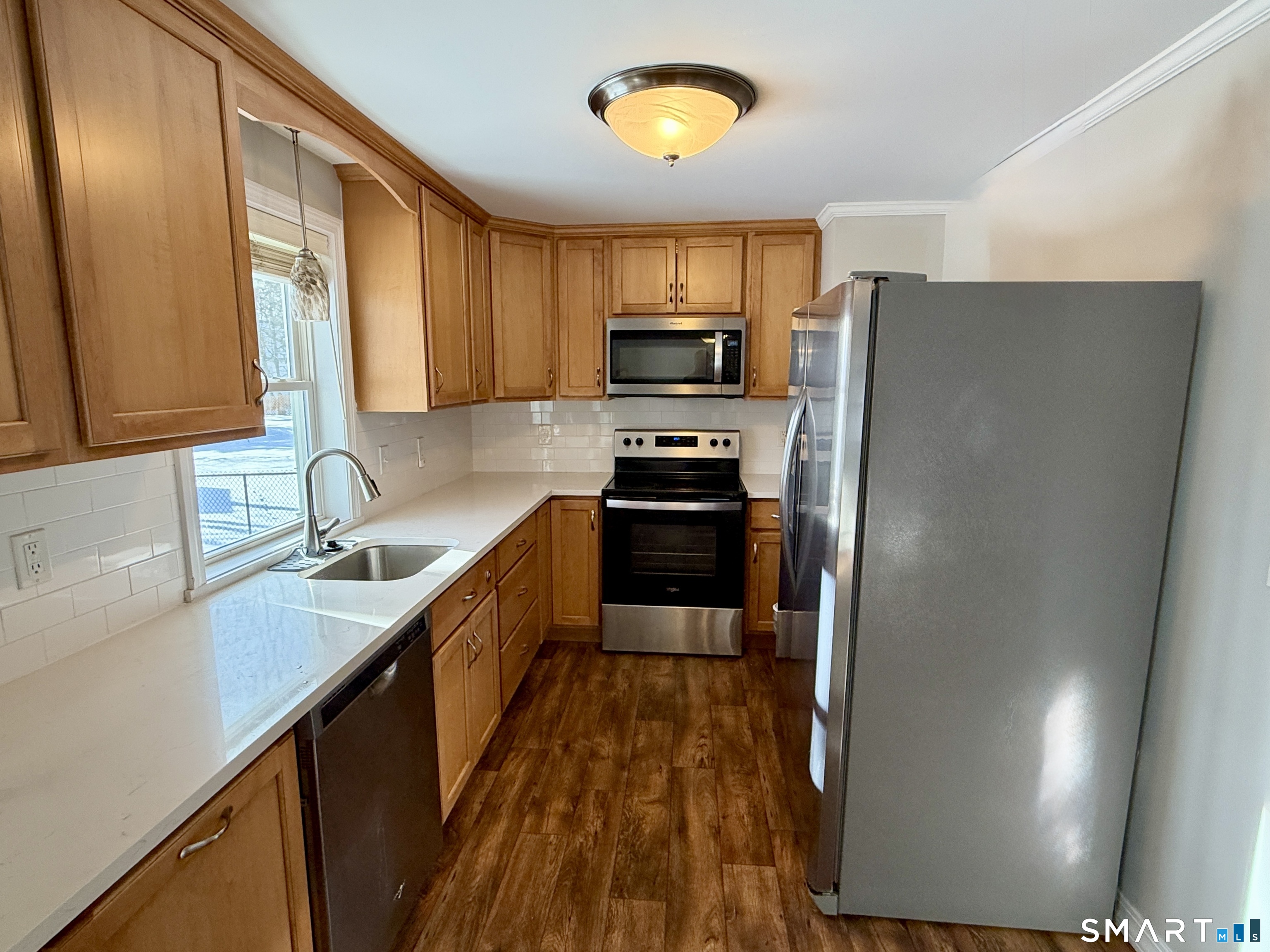 148 Lois Street Torrington, CT 06790 - Photo 5 of 17 a kitchen with stainless steel appliances a refrigerator sink and stove