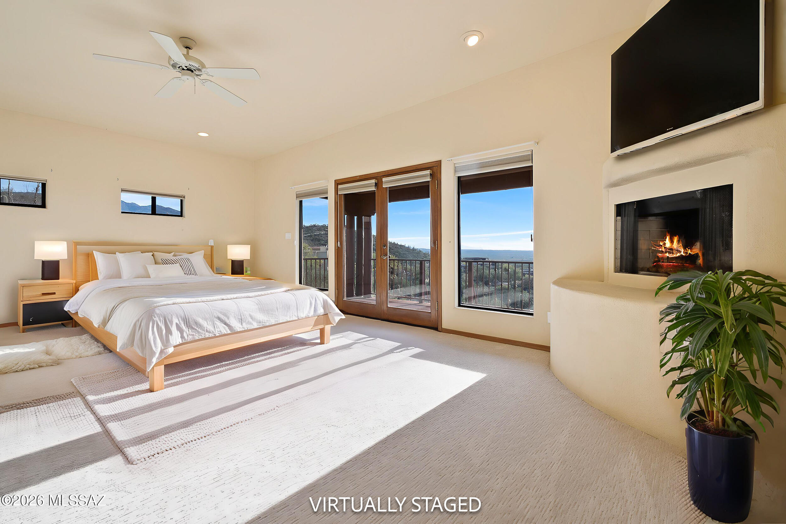 13630 East Sahuaro Sunset Road Tucson, AZ 85749 - Photo 6 of 47 a spacious bedroom with a large bed and a flat screen tv
