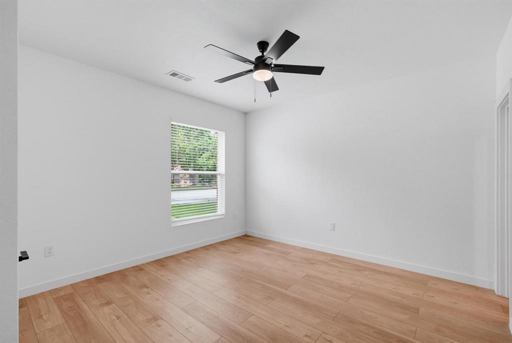 504 South O Connor Road Irving, TX 75060 - Photo 5 of 23 Wood-finish flooring, white baseboards, and a window with horizontal blinds