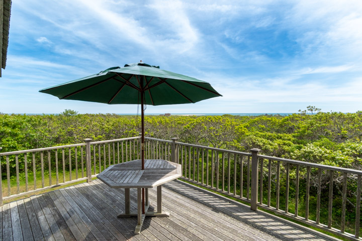 94-21 Tuckernuck Nantucket, MA 02554 - Photo 4 of 20 a view of a balcony with chairs and wooden floor