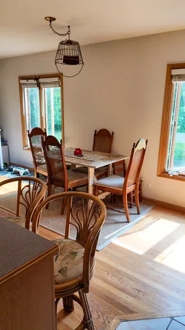 a dining room with furniture and window
