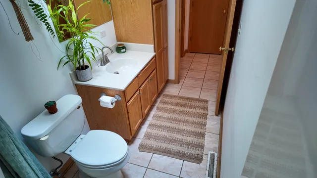 a view of bathroom with a toilet sink and mirror
