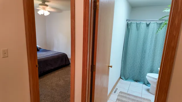 a bedroom with a bed and a mirror