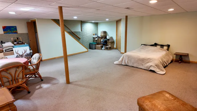 a bedroom with furniture and a chair