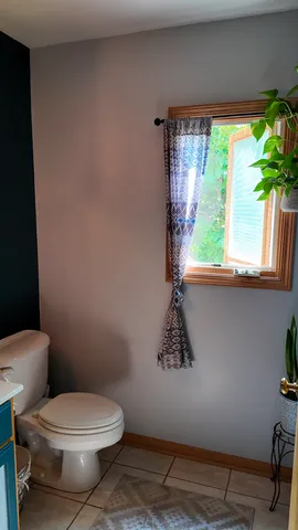 a white toilet sitting next to a window