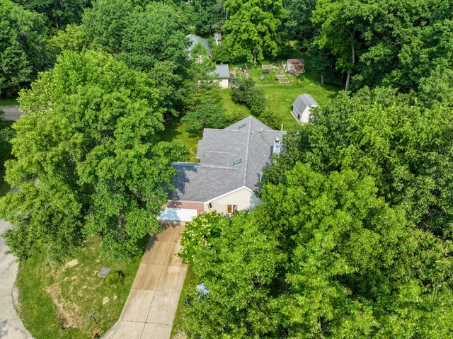 an aerial view of a house with a yard