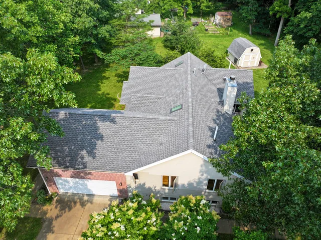 an aerial view of a house with outdoor space and street view