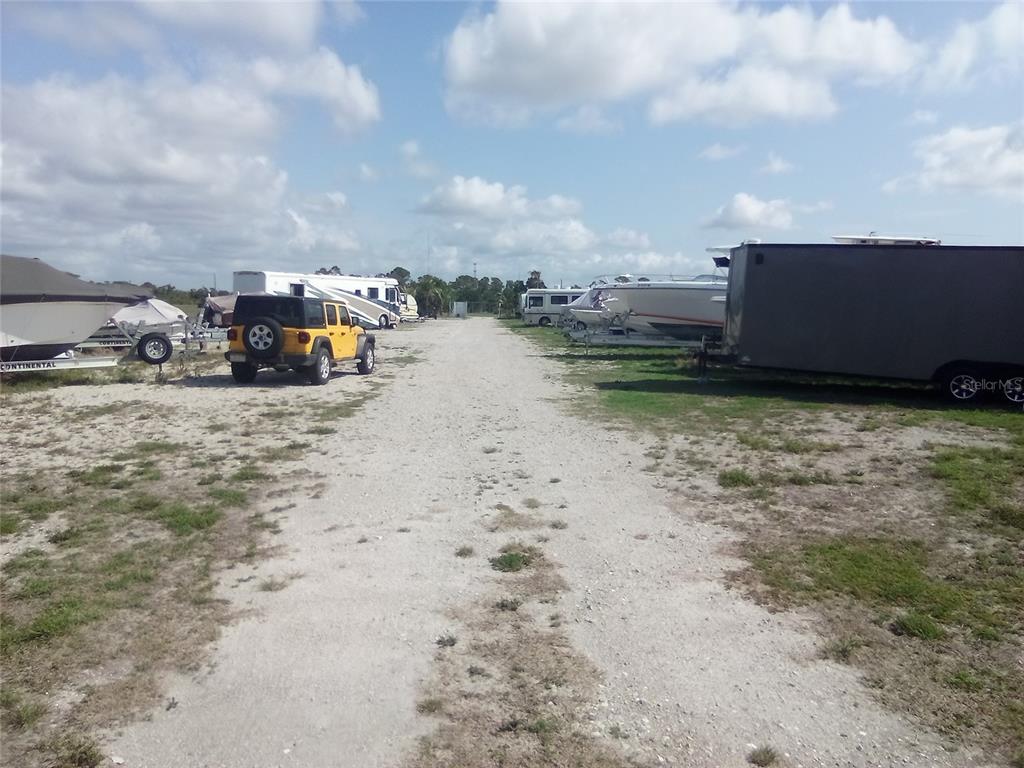102 Harness Road Placida, FL 33946 - Photo 7 of 12 a view of a dry yard with wooden fence