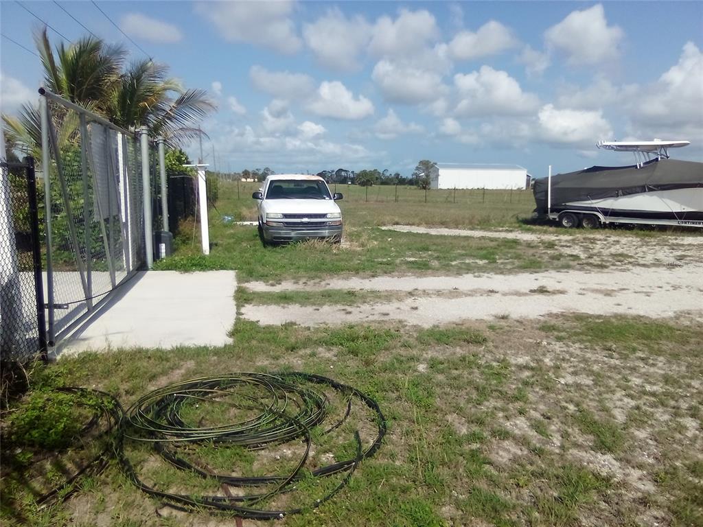 102 Harness Road Placida, FL 33946 - Photo 8 of 12 a backyard of a house with table and chairs