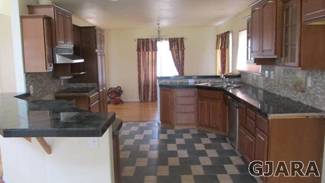 2153 I Road Grand Junction, CO 81505 - Photo 3 of 13 a kitchen with stainless steel appliances granite countertop a sink stove and cabinets