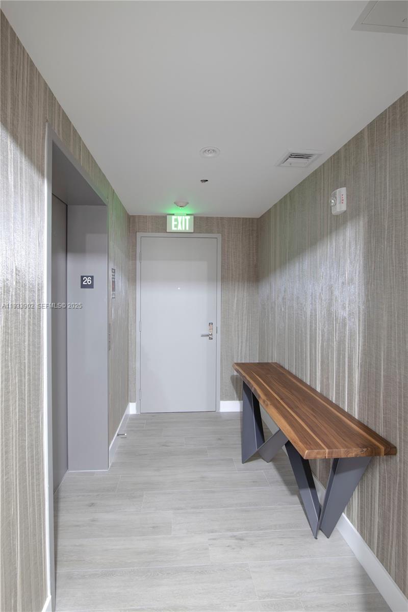 488 Northeast 18th Street, Unit 2610 Miami, FL 33132 - Photo 4 of 21 a room with wooden bench and wooden floor