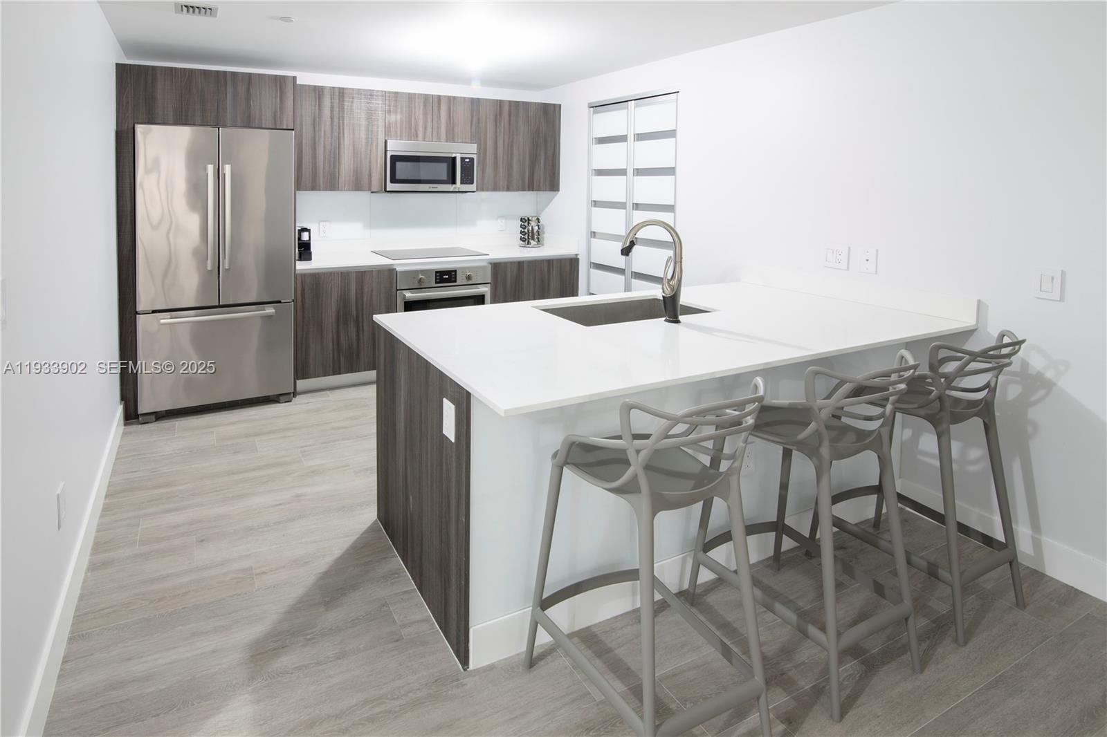 488 Northeast 18th Street, Unit 2610 Miami, FL 33132 - Photo 9 of 21 a kitchen with stainless steel appliances a stove a refrigerator and a refrigerator