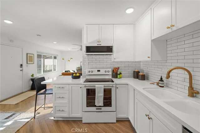 a kitchen with a sink cabinets and appliances
