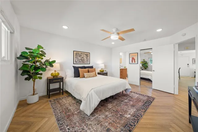 a bedroom with a bed and a potted plant