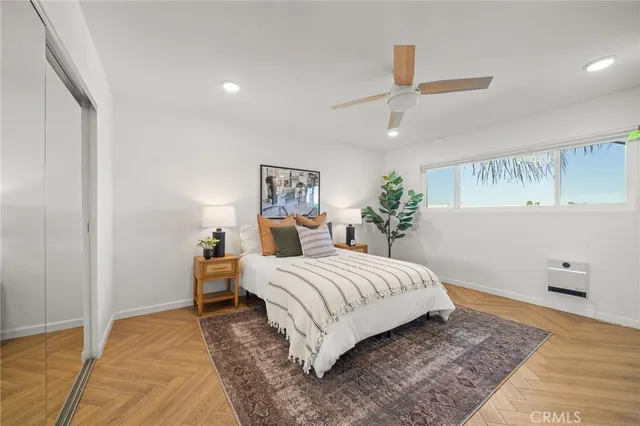 a bedroom with a large bed and a chandelier