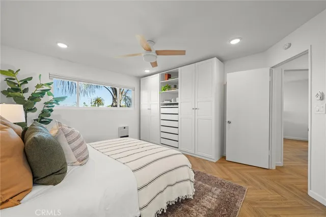 a bedroom with a large bed and a chandelier