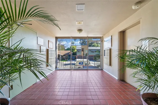a lobby with furniture and a potted plant