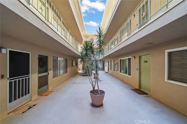 a hallway with stairs and wooden floor