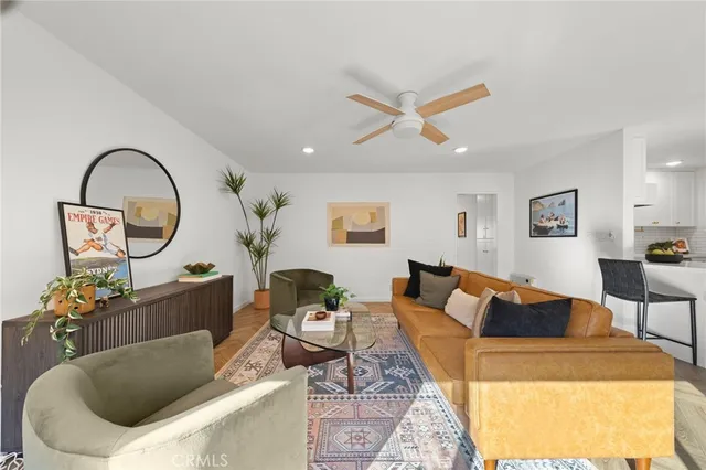 a living room with furniture a rug and a mirror