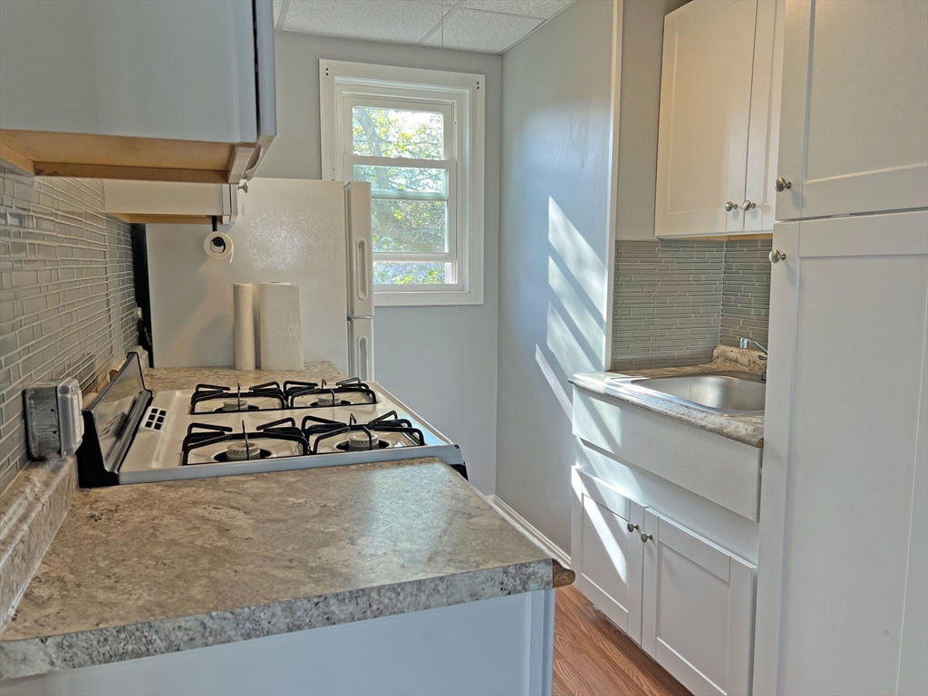 280 Buffinton Street Fall River, MA 02721 - Photo 3 of 21 a kitchen with granite countertop a sink stove and cabinets