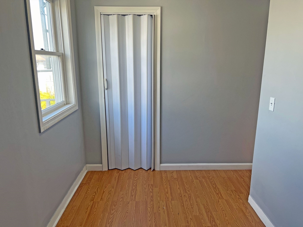 280 Buffinton Street Fall River, MA 02721 - Photo 9 of 21 a view of an empty room with wooden floor and a window