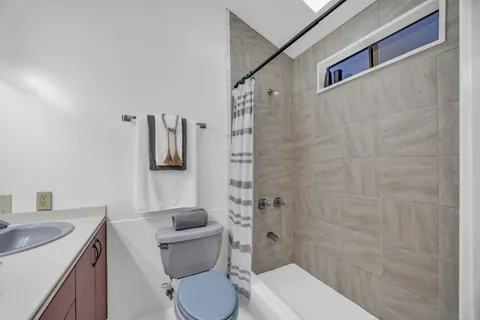 a white toilet sitting next to a bathroom sink