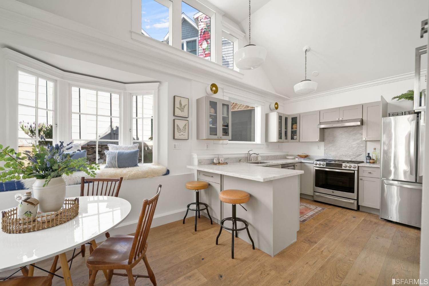 a large kitchen with a table and chairs
