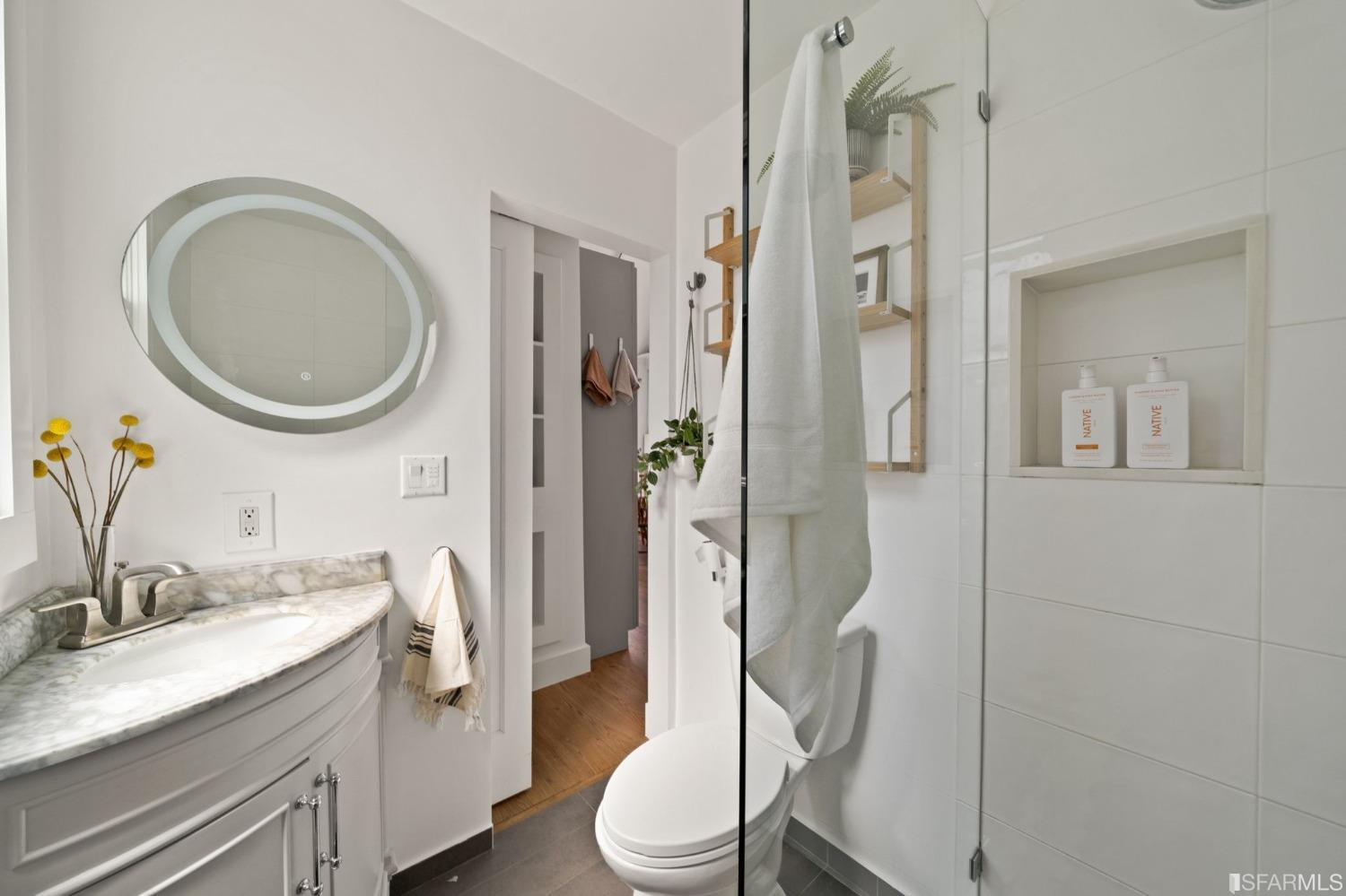 3045 Castro Street San Francisco, CA 94131 - Photo 23 of 44 a bathroom with a granite countertop sink toilet a mirror and shower