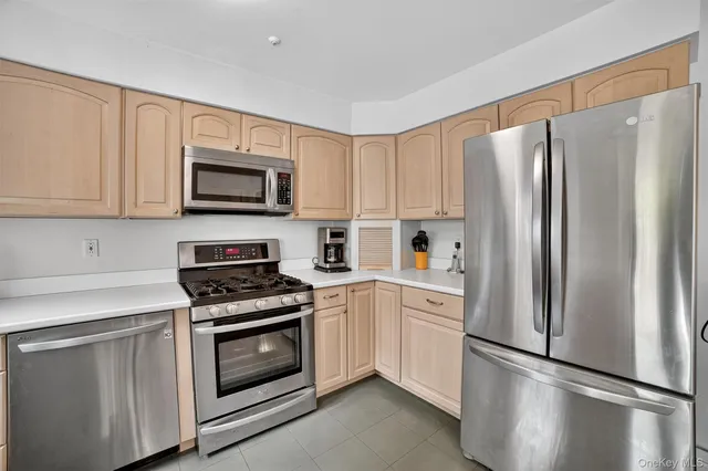 a kitchen with cabinets stainless steel appliances and wooden cabinets