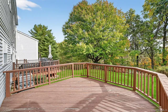 a view of balcony with wooden floor and fence