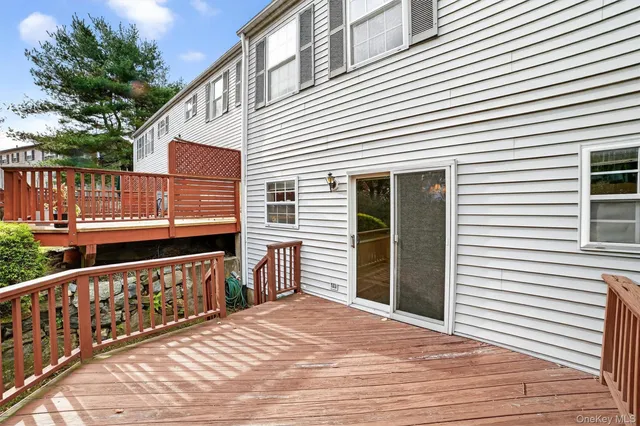 a view of a wooden deck with a barbeque