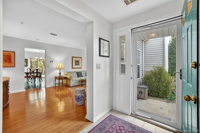 a living room with furniture and a glass door