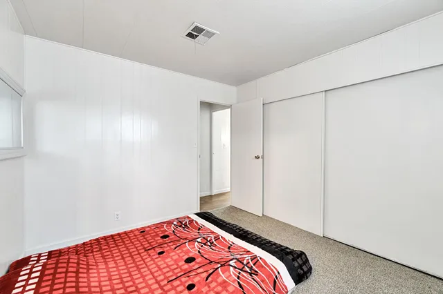 a bedroom with a bed and a lamp