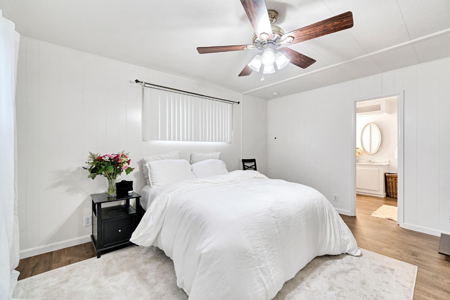 3556 North Duke Avenue, Unit 165 Fresno, CA 93727 - Photo 18 of 25 a bedroom with a bed and a chandelier