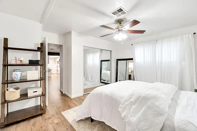 a bedroom with a large bed and a chandelier