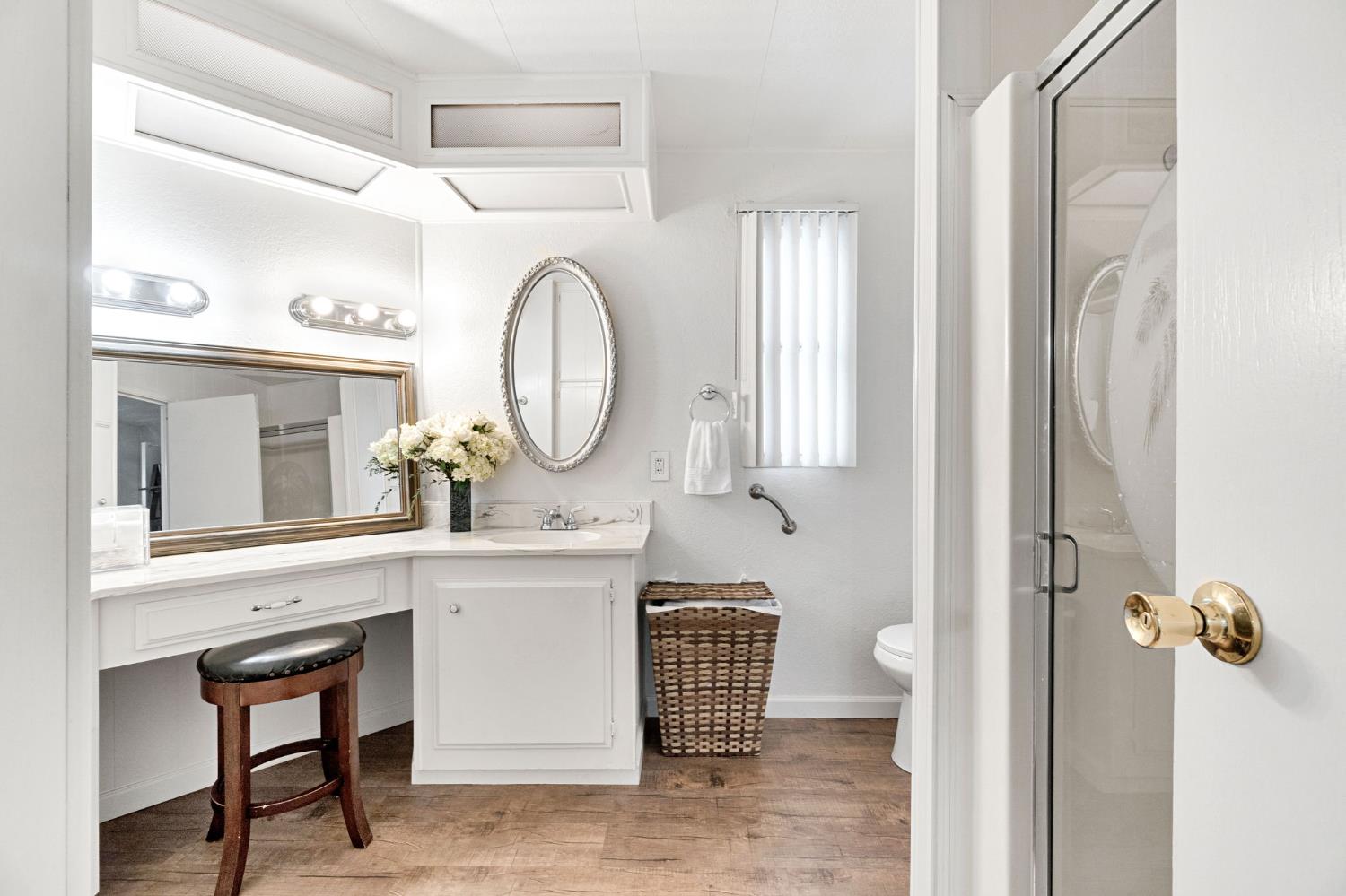 3556 North Duke Avenue, Unit 165 Fresno, CA 93727 - Photo 20 of 25 a bathroom with a sink a mirror and a toilet