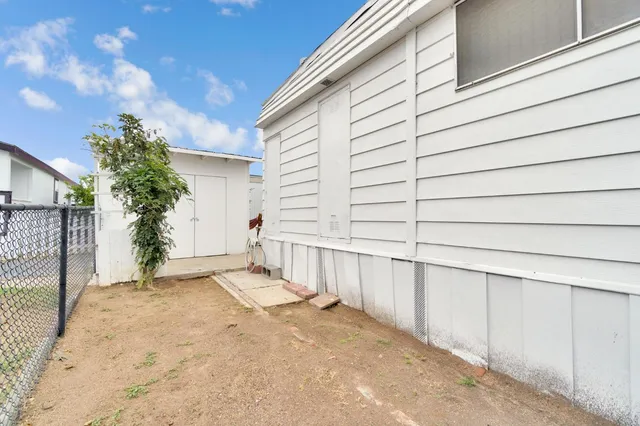 a view of a backyard with wooden fence