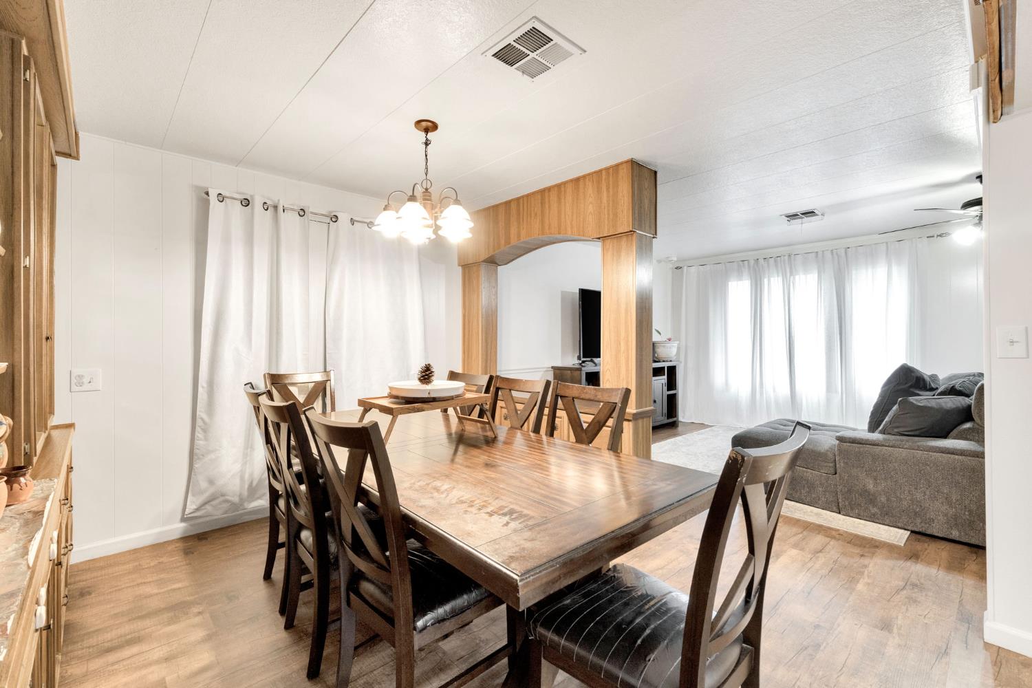 3556 North Duke Avenue, Unit 165 Fresno, CA 93727 - Photo 7 of 25 a view of a a dining room with furniture window and wooden floor