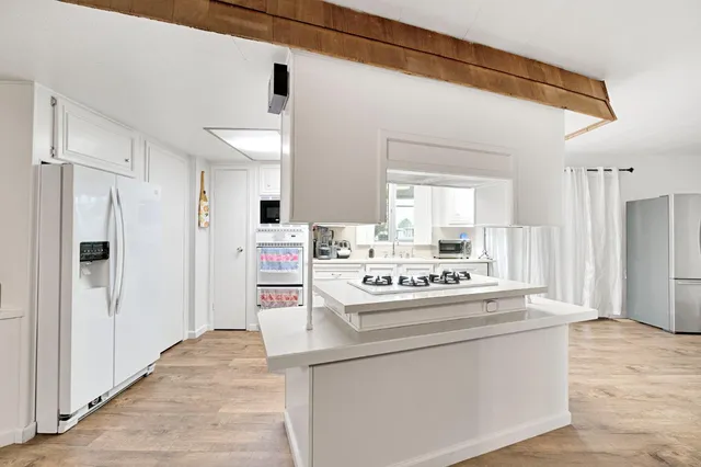 a view of kitchen cabinets and refrigerator