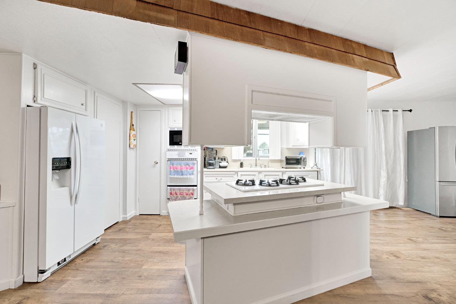 3556 North Duke Avenue, Unit 165 Fresno, CA 93727 - Photo 8 of 25 a view of kitchen cabinets and refrigerator