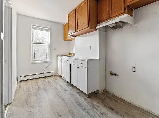 a view of a kitchen with electric appliances