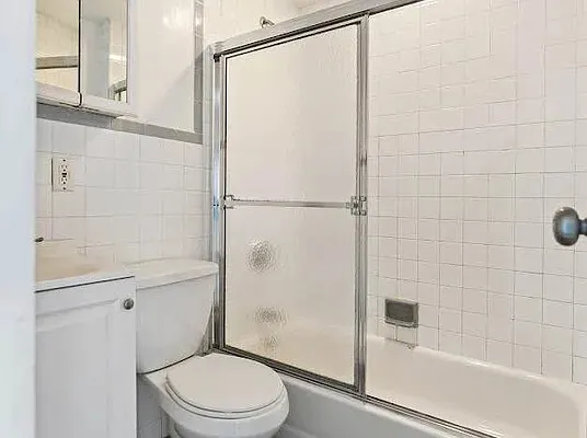 a bathroom with a shower a toilet and a sink