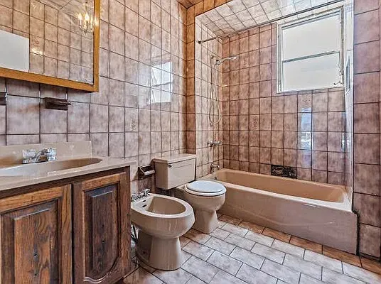 a white toilet sitting next to a bathroom sink