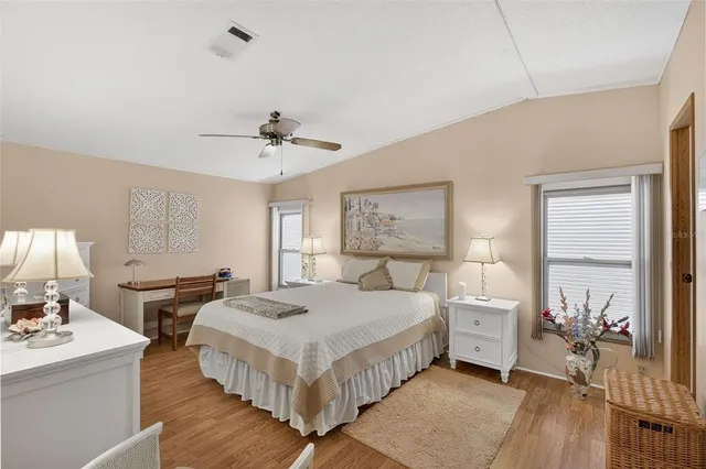 a spacious bedroom with a bed and a table