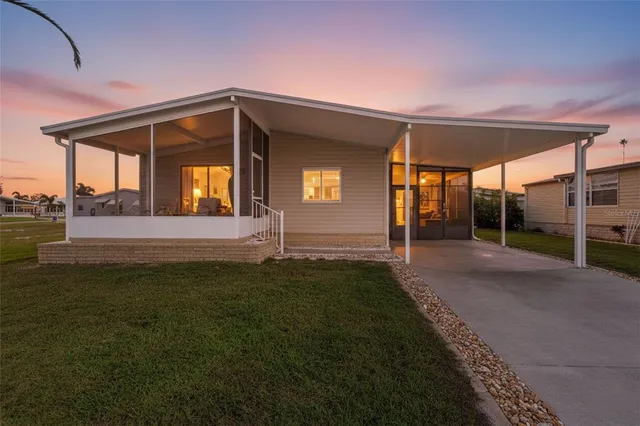 a view of a house with backyard and porch