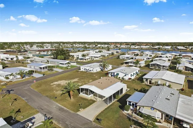 a living room with furniture and a view of kitchen