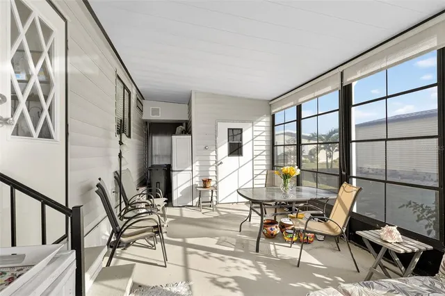a dining room with furniture and a floor to ceiling window
